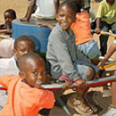 children in africa playing on a play pump