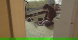 a child using a laptop in her bedroom