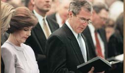 photo of the president and first lady reading from the bible