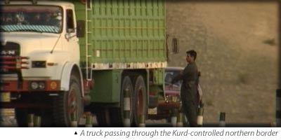 Trucks passing through the Kurd-controlled northern border