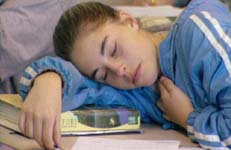 photo of a teen sleeping at a desk