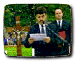 photo of a man speaking into a microphone