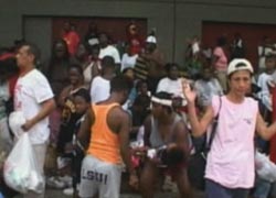 Crowds of refugees from Hurricane Katrina wait for help.