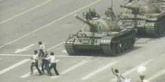 photo of a man being rushed away from a tank